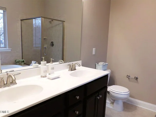 a bathroom with a sink vanity mirror and toilet