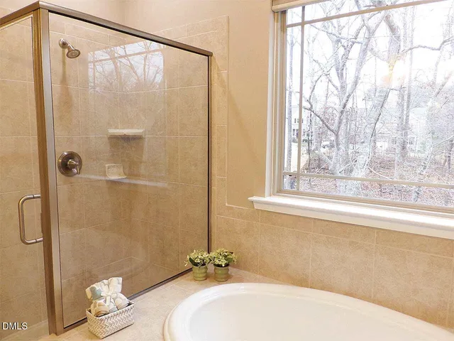 a bathroom with a bathtub and shower