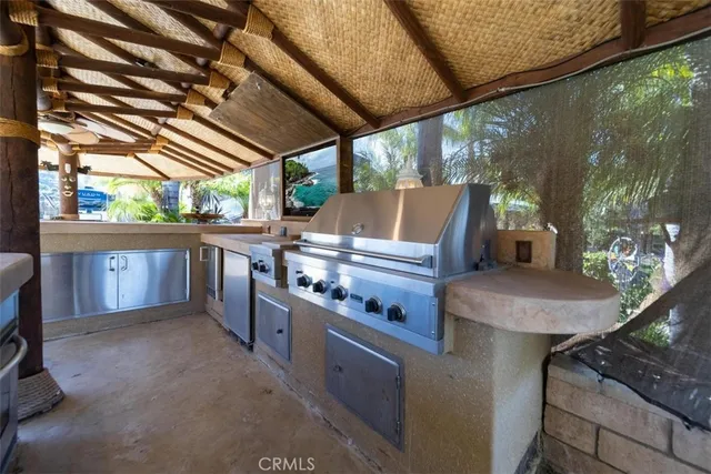a view of a porch with furniture and a backyard