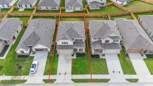 an aerial view of multiple houses with yard