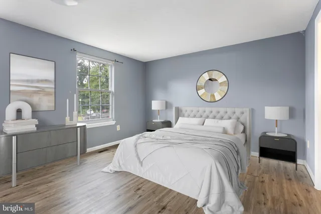 a bedroom with a bed and a lamp