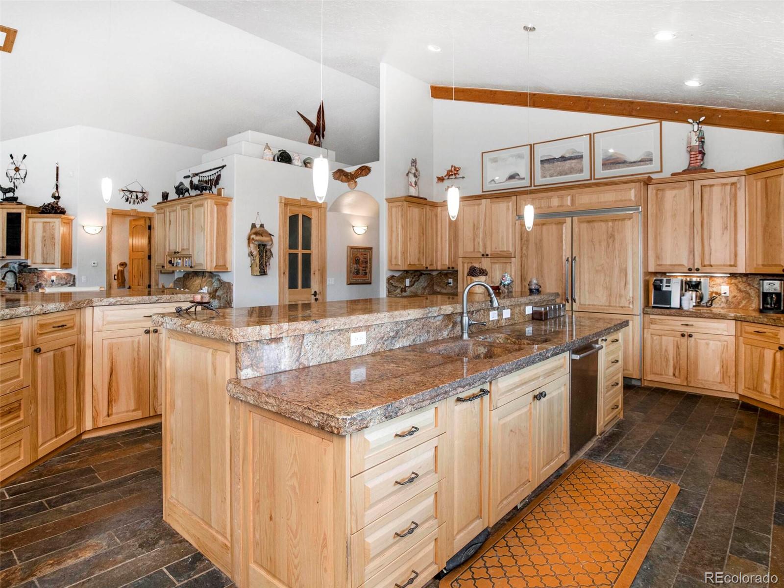 577 Bear Meadow Trail Evergreen, CO 80439 - Photo 12 of 40 a kitchen with stainless steel appliances granite countertop a sink and cabinets