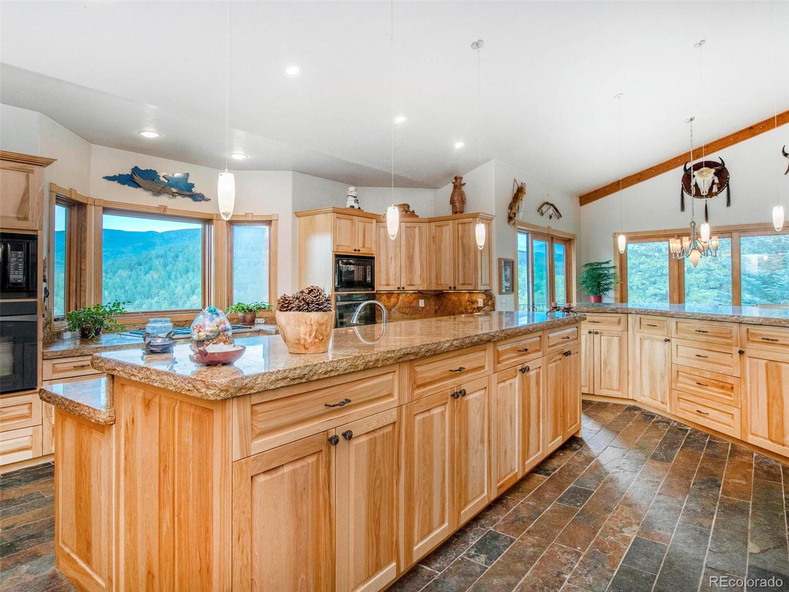 577 Bear Meadow Trail Evergreen, CO 80439 - Photo 13 of 40 a kitchen with counter top space and a sink