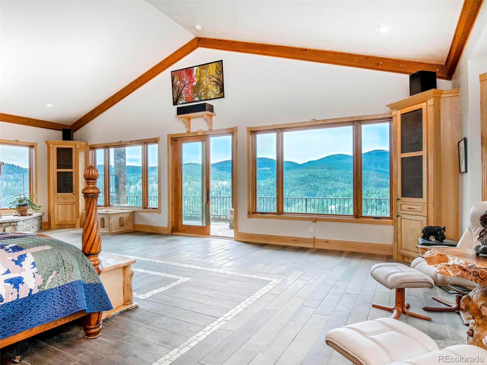 577 Bear Meadow Trail Evergreen, CO 80439 - Photo 18 of 40 a bedroom with furniture and a large window