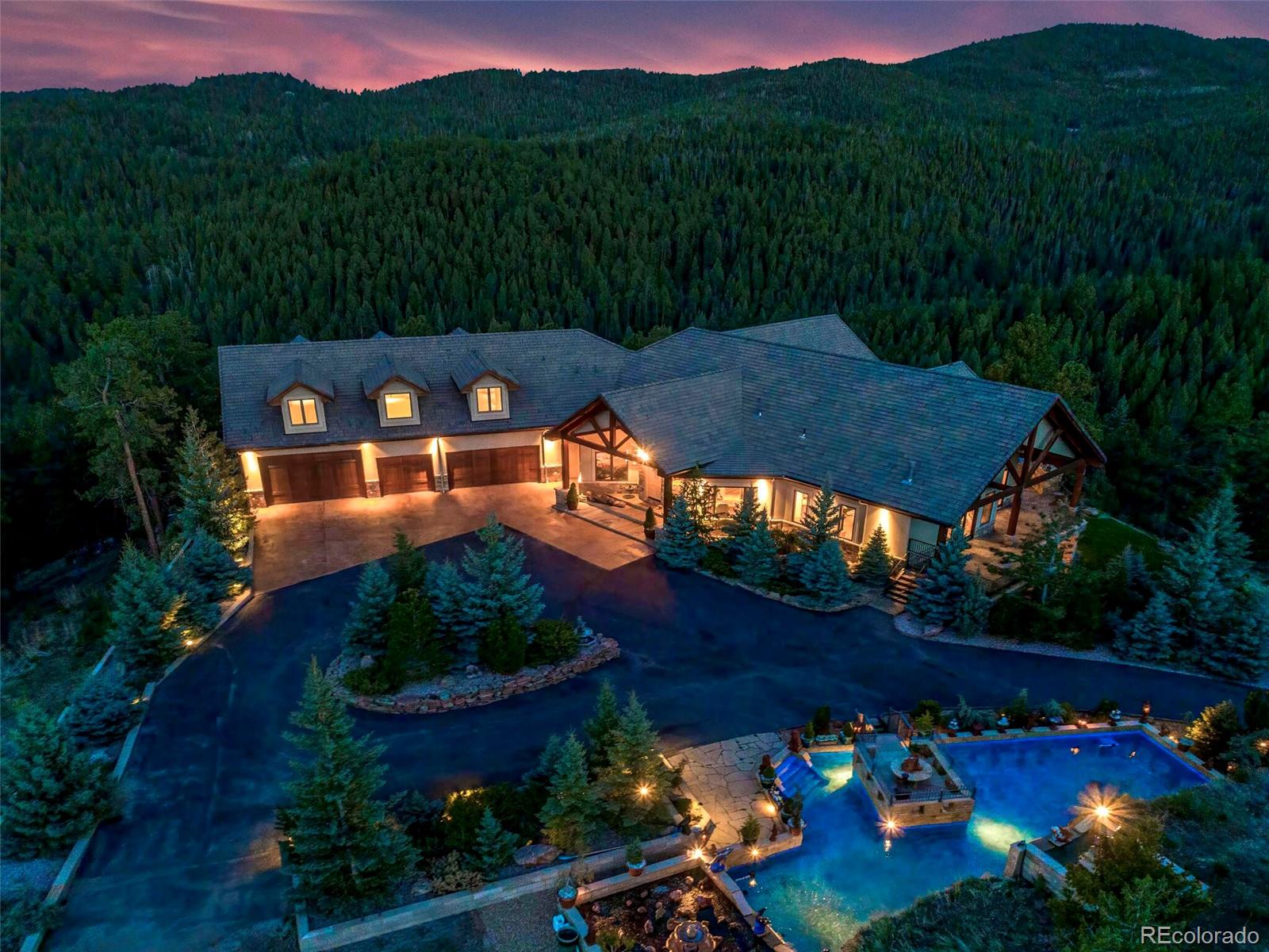 577 Bear Meadow Trail Evergreen, CO 80439 - Photo 2 of 40 a view of a swimming pool with a patio