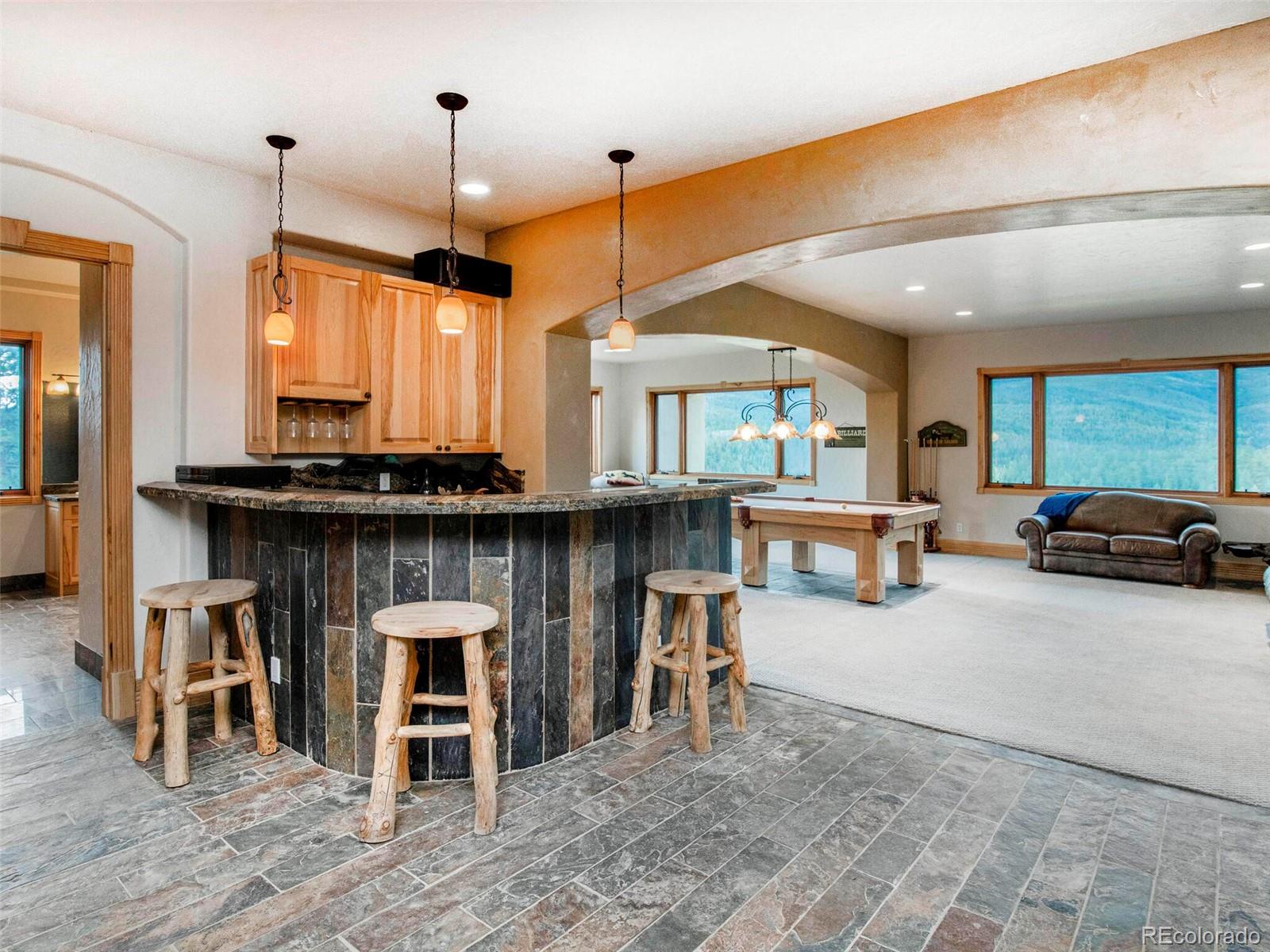 577 Bear Meadow Trail Evergreen, CO 80439 - Photo 26 of 40 a living room with furniture a window and kitchen view