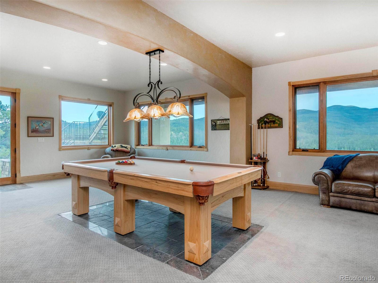 577 Bear Meadow Trail Evergreen, CO 80439 - Photo 27 of 40 a room with pool table windows and furniture