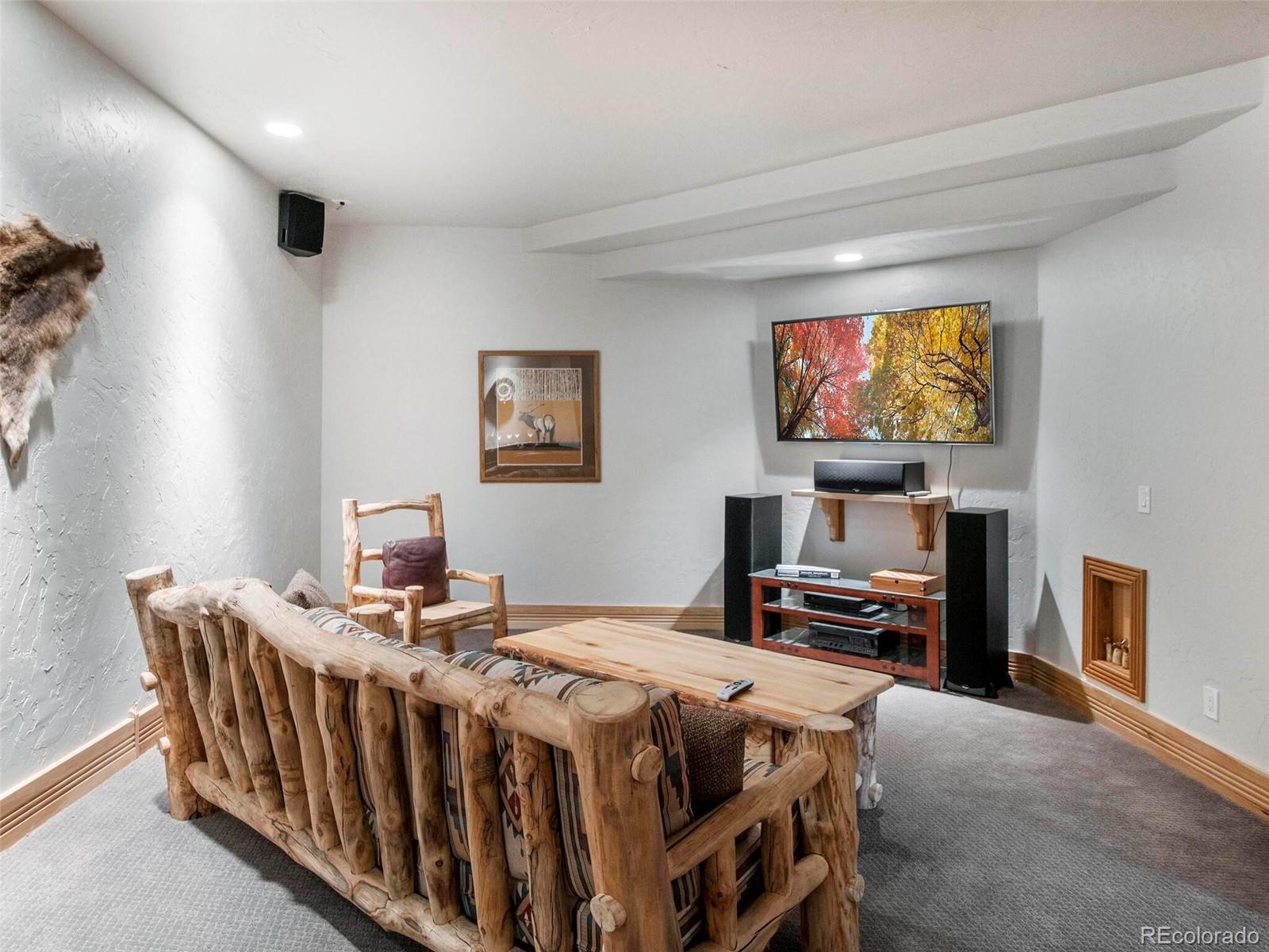 577 Bear Meadow Trail Evergreen, CO 80439 - Photo 28 of 40 a bedroom with a bed and a flat screen tv