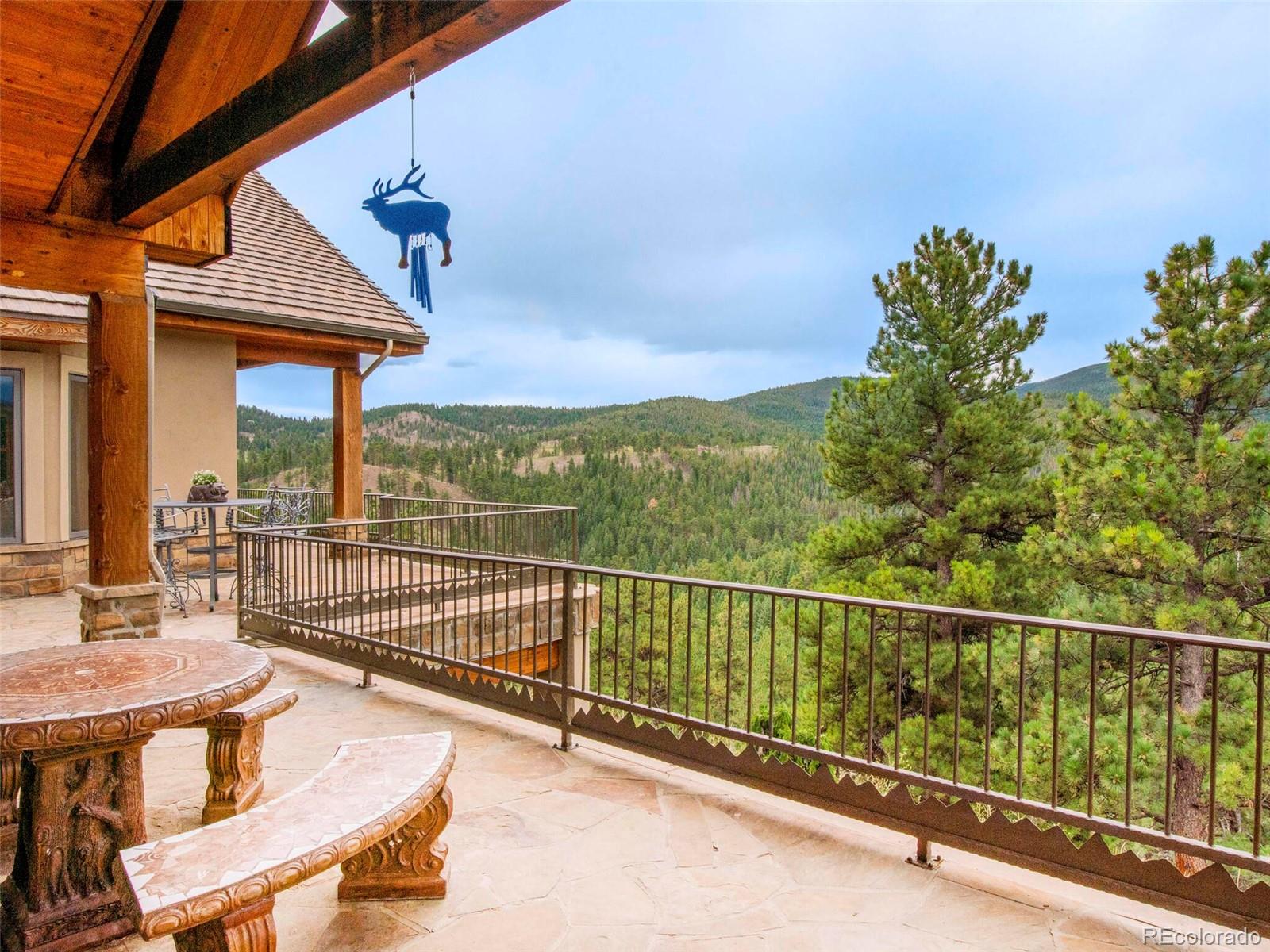 577 Bear Meadow Trail Evergreen, CO 80439 - Photo 3 of 40 a view of a chairs and table in the balcony