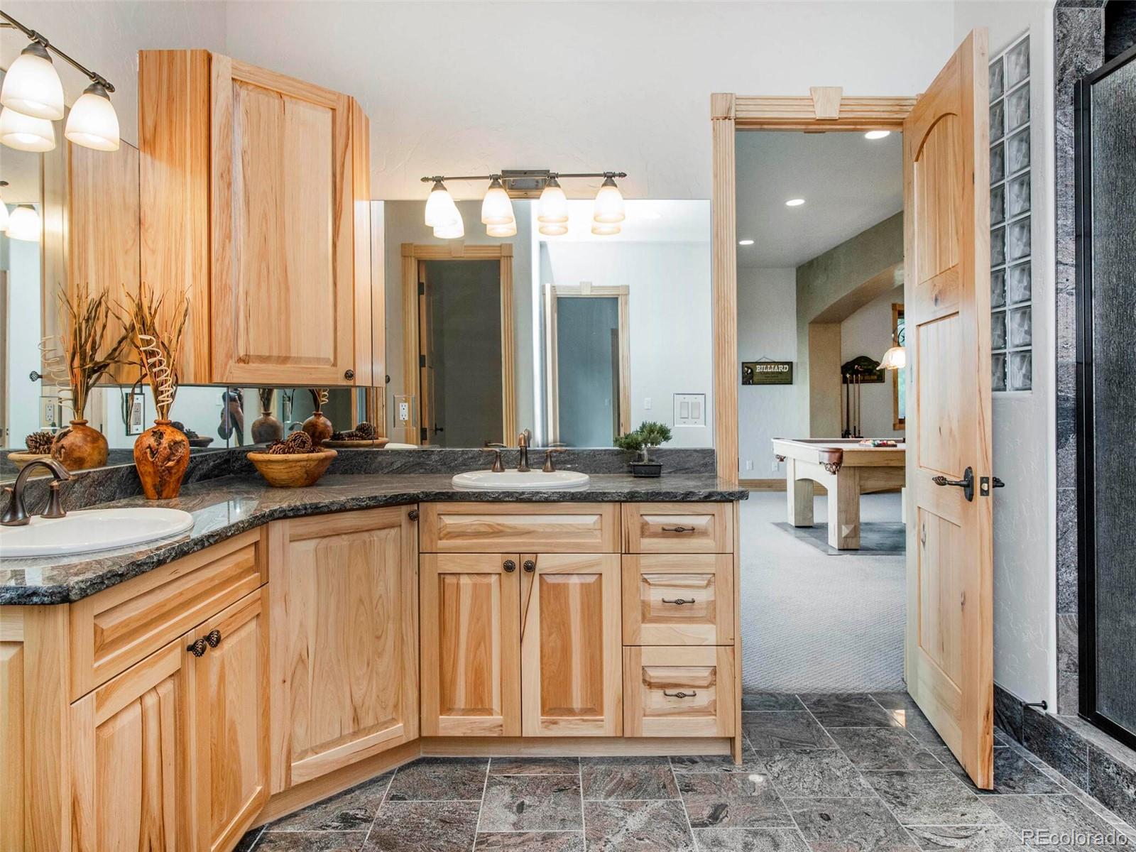 577 Bear Meadow Trail Evergreen, CO 80439 - Photo 31 of 40 a bathroom with a sink and a mirror
