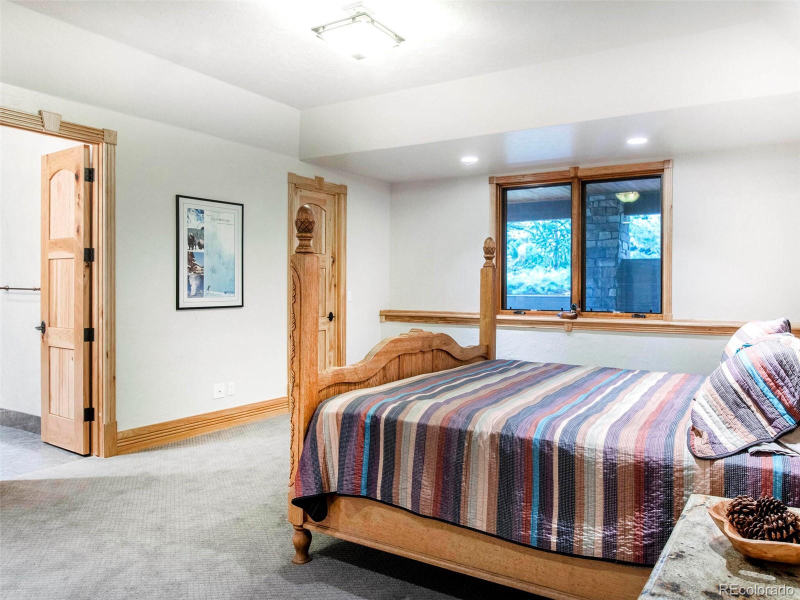 577 Bear Meadow Trail Evergreen, CO 80439 - Photo 34 of 40 a bedroom with a bed and window