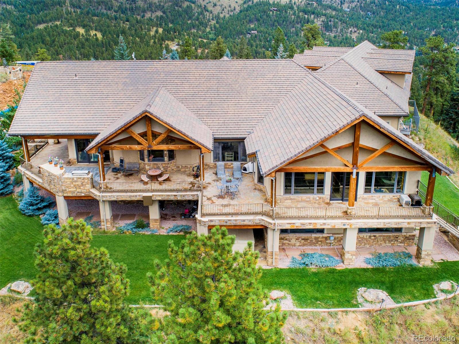 577 Bear Meadow Trail Evergreen, CO 80439 - Photo 38 of 40 a aerial view of a white house with a yard and potted plants