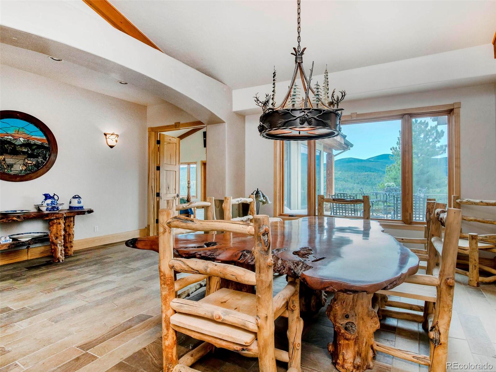 577 Bear Meadow Trail Evergreen, CO 80439 - Photo 8 of 40 a view of a dining room with furniture window and wooden floor