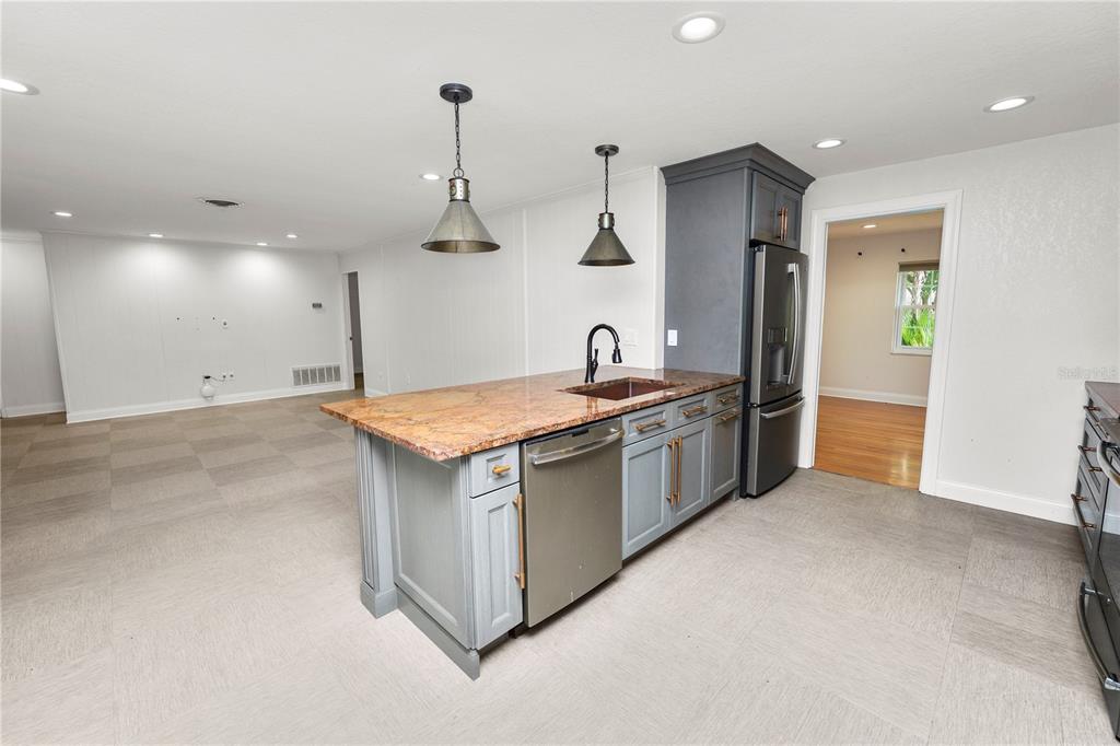 509 Robroy Street Lakeland, FL 33813 - Photo 11 of 51 a kitchen with stainless steel appliances granite countertop a sink and a refrigerator