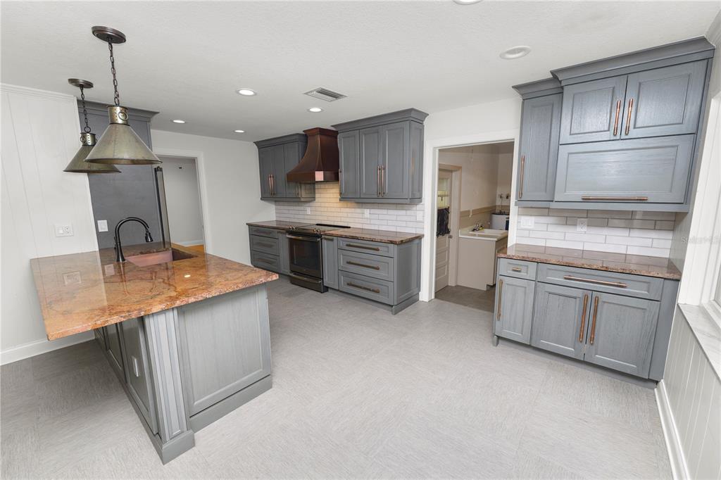 509 Robroy Street Lakeland, FL 33813 - Photo 13 of 51 a kitchen with white cabinets and stainless steel appliances