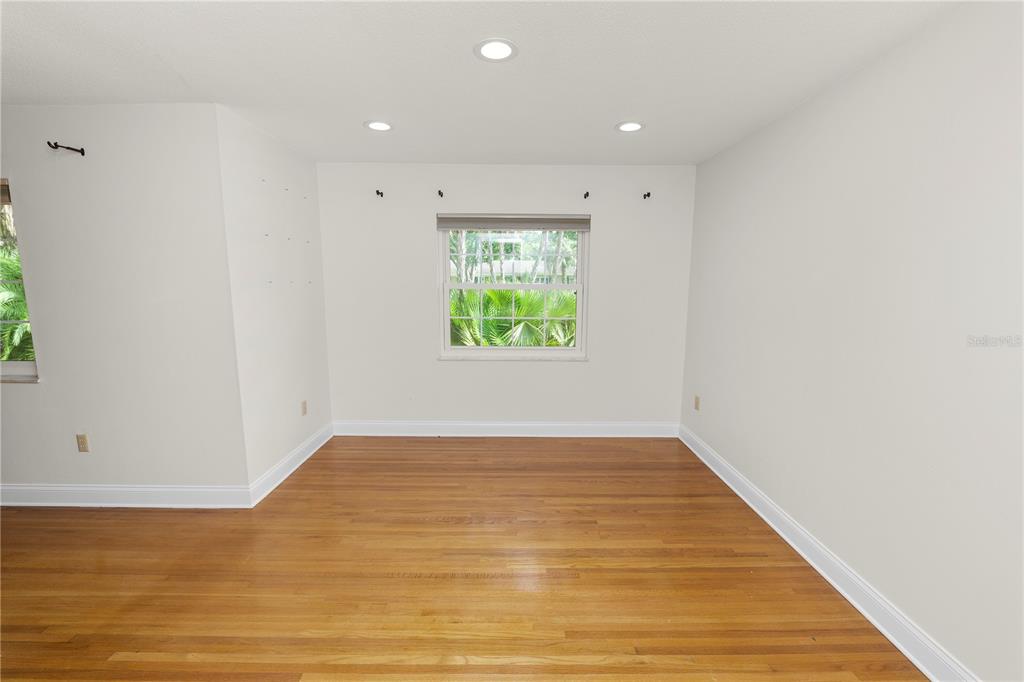 509 Robroy Street Lakeland, FL 33813 - Photo 20 of 51 a view of an empty room with wooden floor and a window