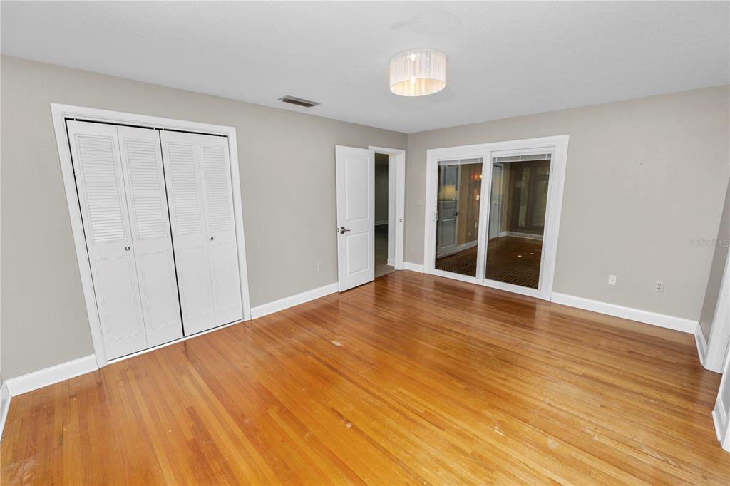 509 Robroy Street Lakeland, FL 33813 - Photo 27 of 51 a view of empty room with wooden floor and fan