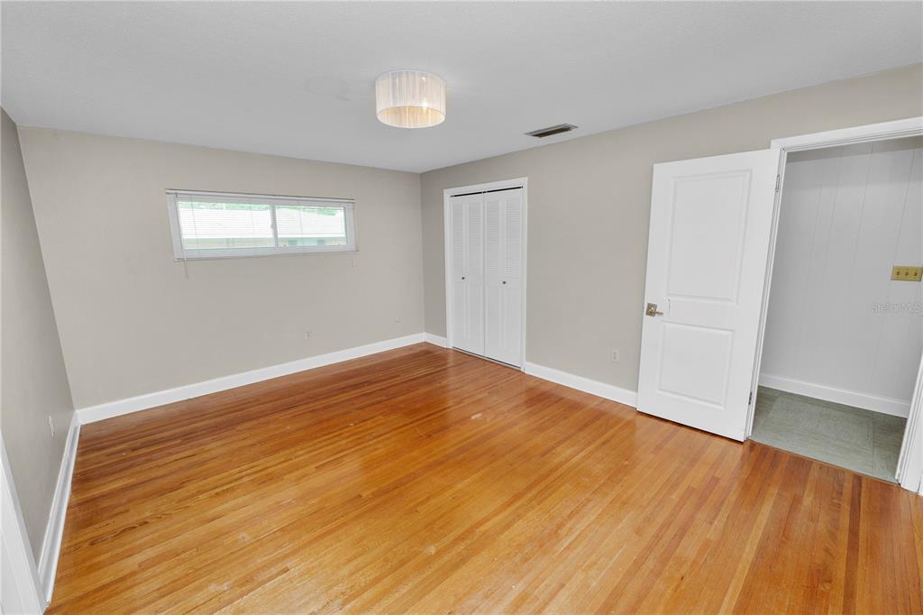 509 Robroy Street Lakeland, FL 33813 - Photo 28 of 51 a view of empty room with wooden floor and fan