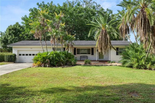 a front view of a house with yard and garage