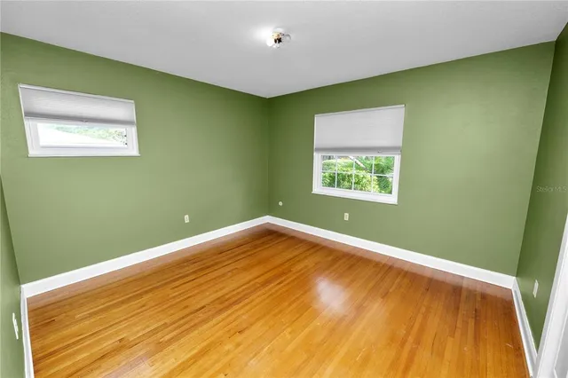 a kitchen with kitchen island white cabinets and refrigerator
