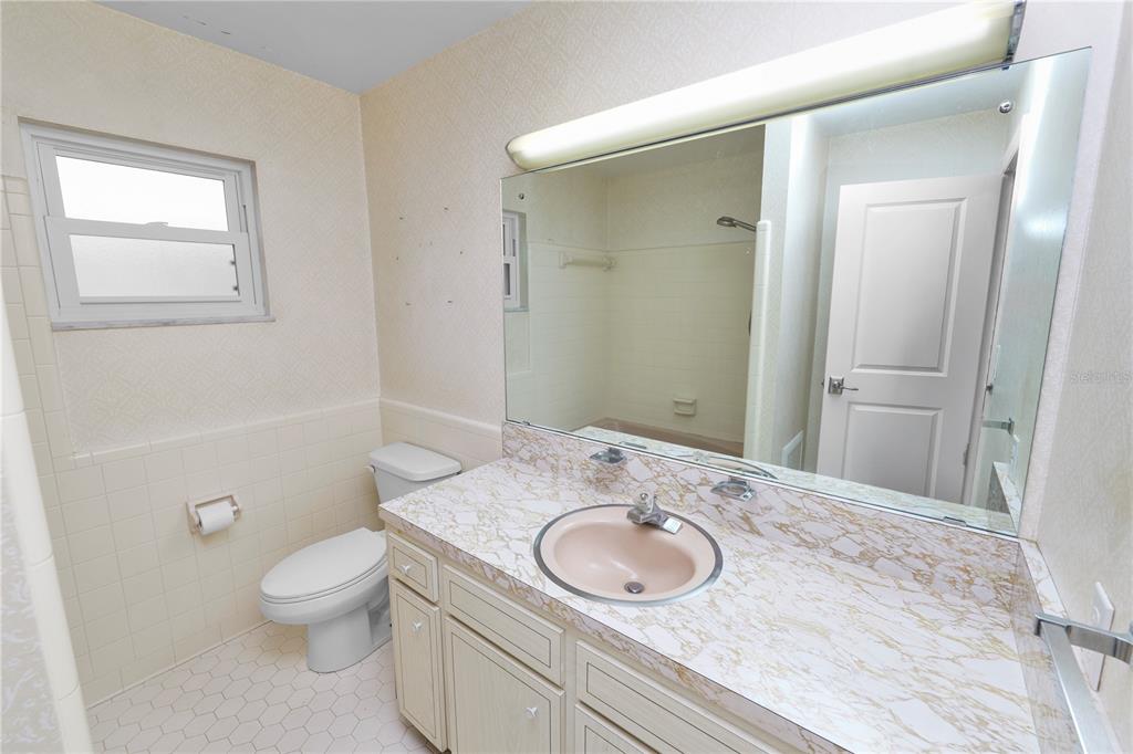 509 Robroy Street Lakeland, FL 33813 - Photo 35 of 51 a bathroom with a sink and mirror with toilet