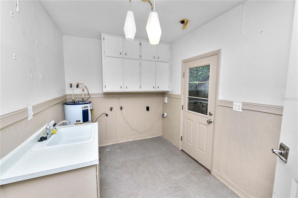509 Robroy Street Lakeland, FL 33813 - Photo 36 of 51 a kitchen with kitchen island white cabinets and refrigerator