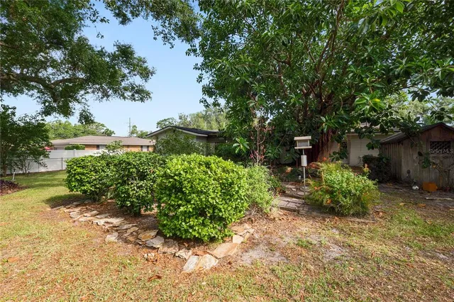 a view of a backyard with plants and a patio