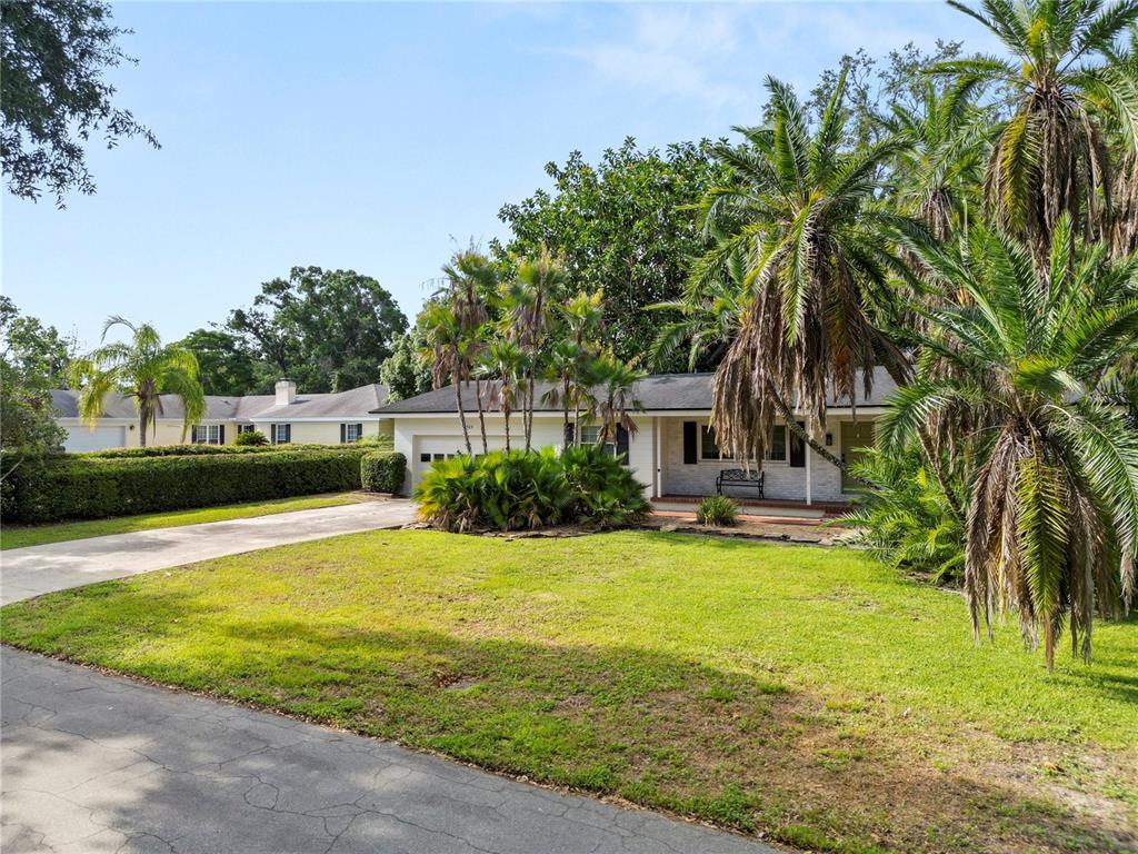 509 Robroy Street Lakeland, FL 33813 - Photo 51 of 51 a view of a swimming pool with a garden and trees