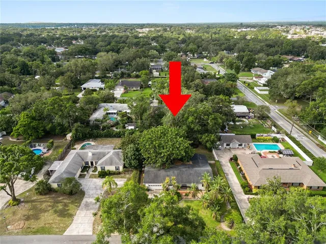an aerial view of residential houses with outdoor space and street view