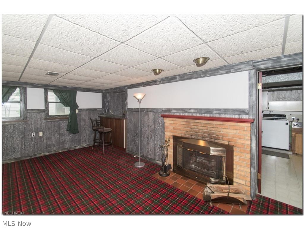 1443 Clearview Road Cleveland, OH 44124 - Photo 14 of 19 Recreation Room in the Basement is set up for entertaining ! Stone fireplace, paneled walls, finished ceiling, and in the corner, a bar.