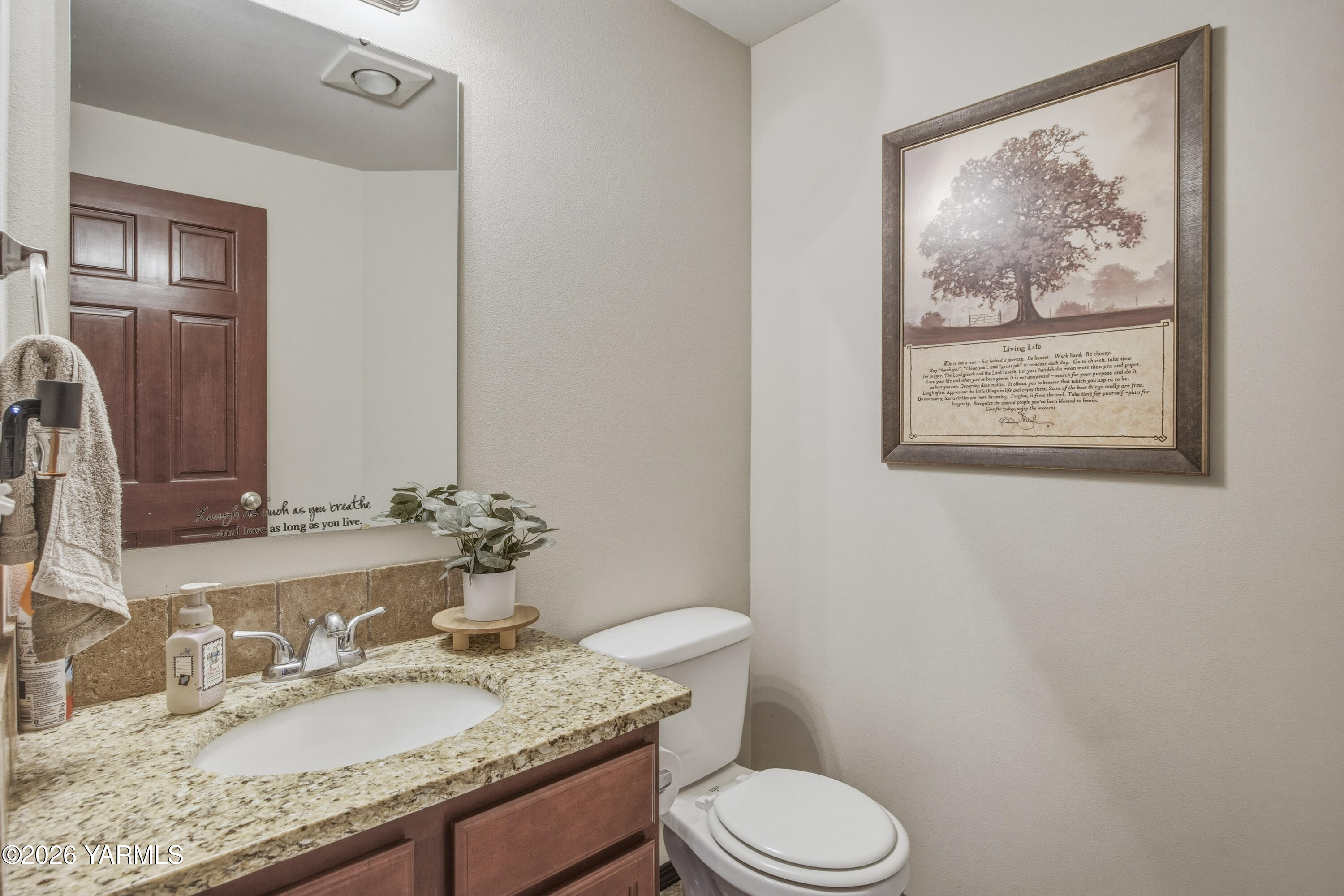 2050 Olmstead Road Grandview, WA 98930 - Photo 36 of 60 a bathroom with a granite countertop toilet sink and mirror