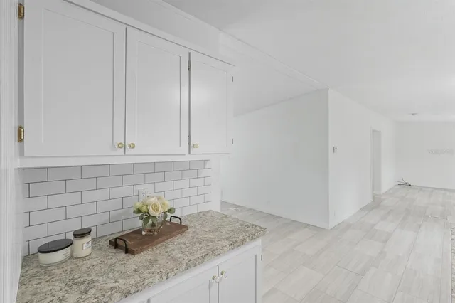 a kitchen with white cabinets