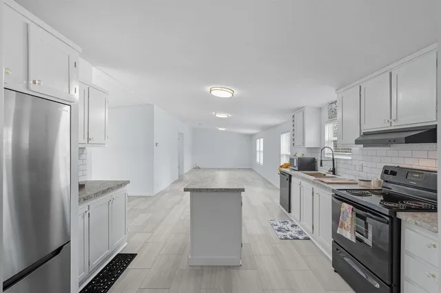 a kitchen with cabinets and stainless steel appliances