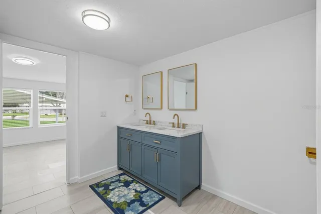 a room with a sink and a mirror