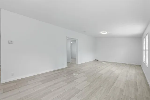 a view of an empty room and wooden floor