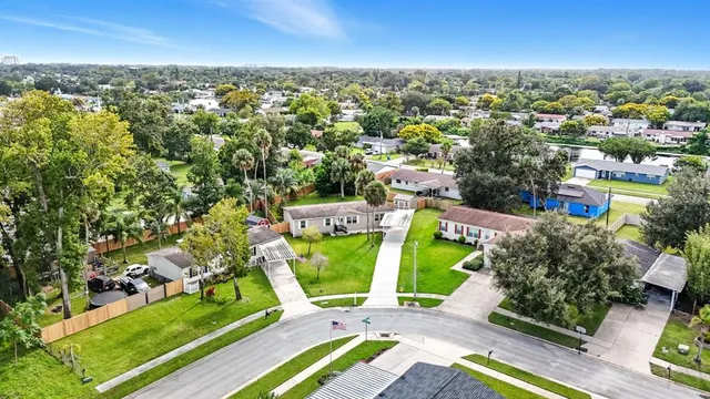 an aerial view of a houses with a yard