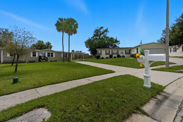 a view of a garden with a house in the background