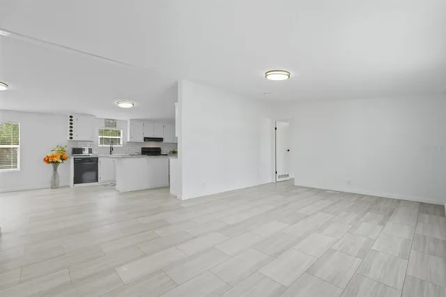 a view of a kitchen with a sink and a refrigerator