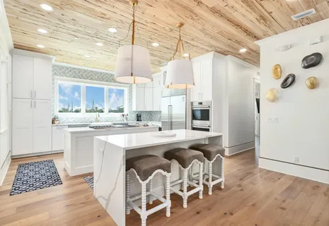 a large kitchen with a table and chairs