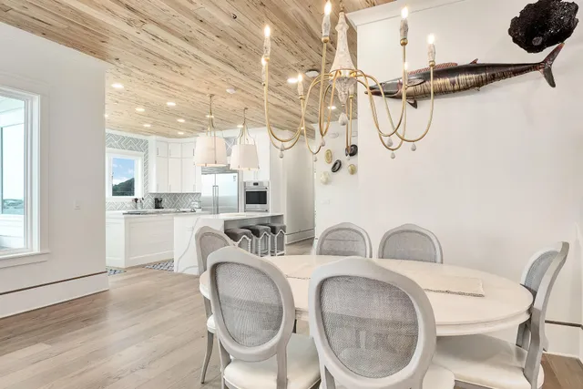 a kitchen with stainless steel appliances granite countertop a white cabinets a sink and a stove