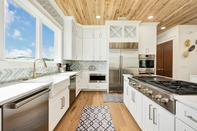 a kitchen with a sink stove and refrigerator