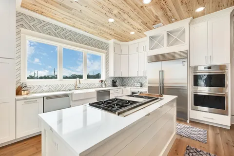 a kitchen with a stove a sink and a refrigerator