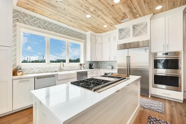 a kitchen with a stove a sink and a refrigerator