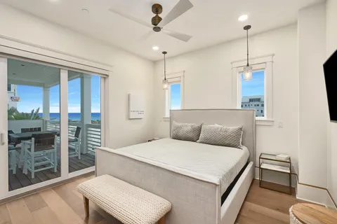 a bedroom with a large bed and a chandelier