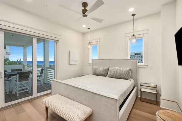 a bedroom with a large bed and a chandelier
