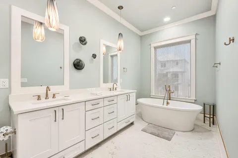 a spacious bathroom with a double vanity sink mirror double and bathtub