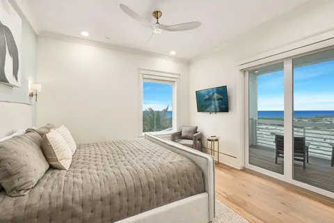 a bedroom with a bed and glass door