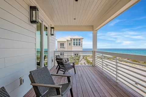 a view of a balcony with chair and wooden floor