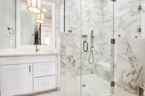 a bathroom with a sink vanity and shower