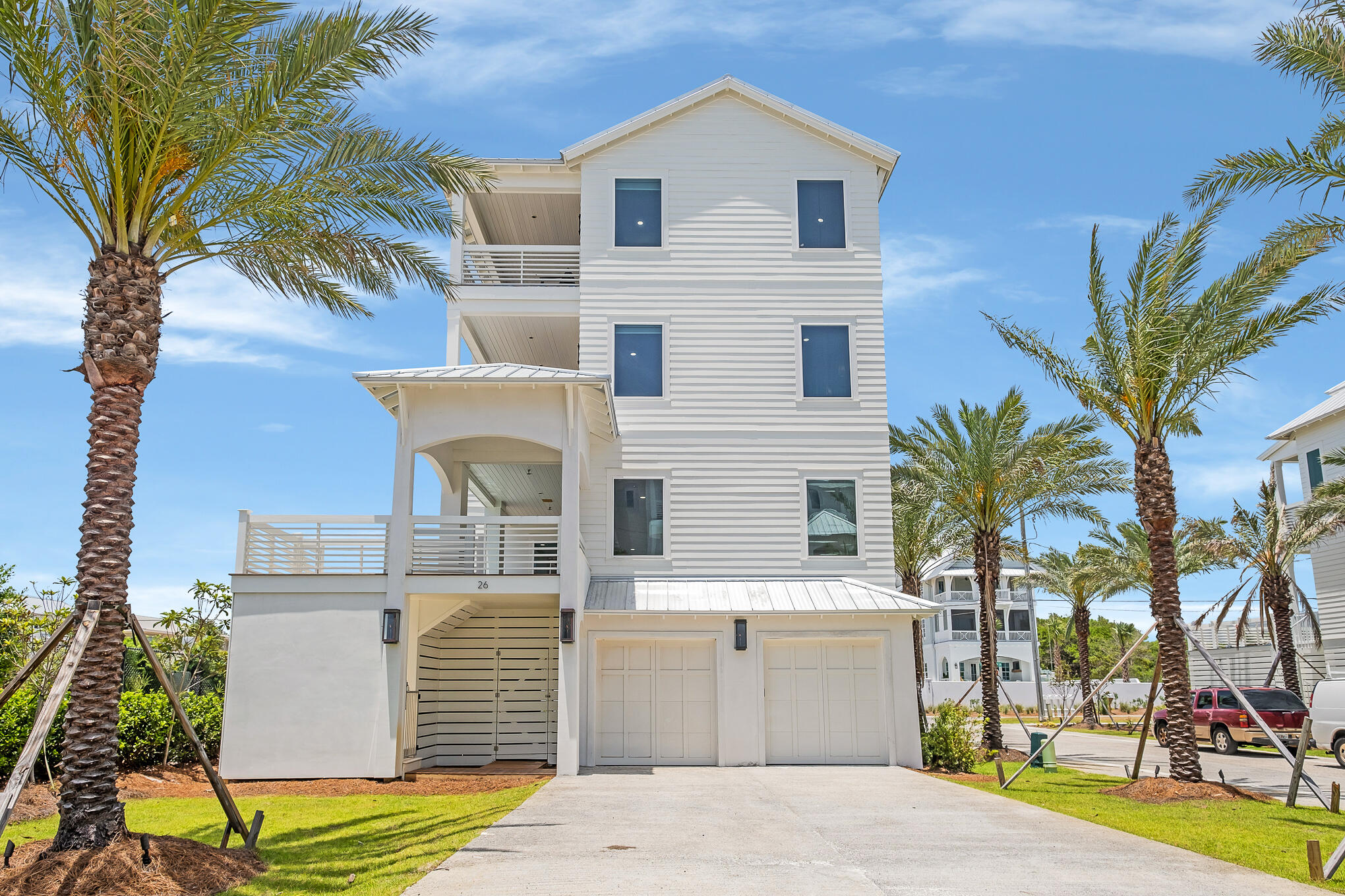 26 Palm Ct Lane Inlet Beach, FL 32461 - Photo 38 of 43 a front view of a house with a yard and garage